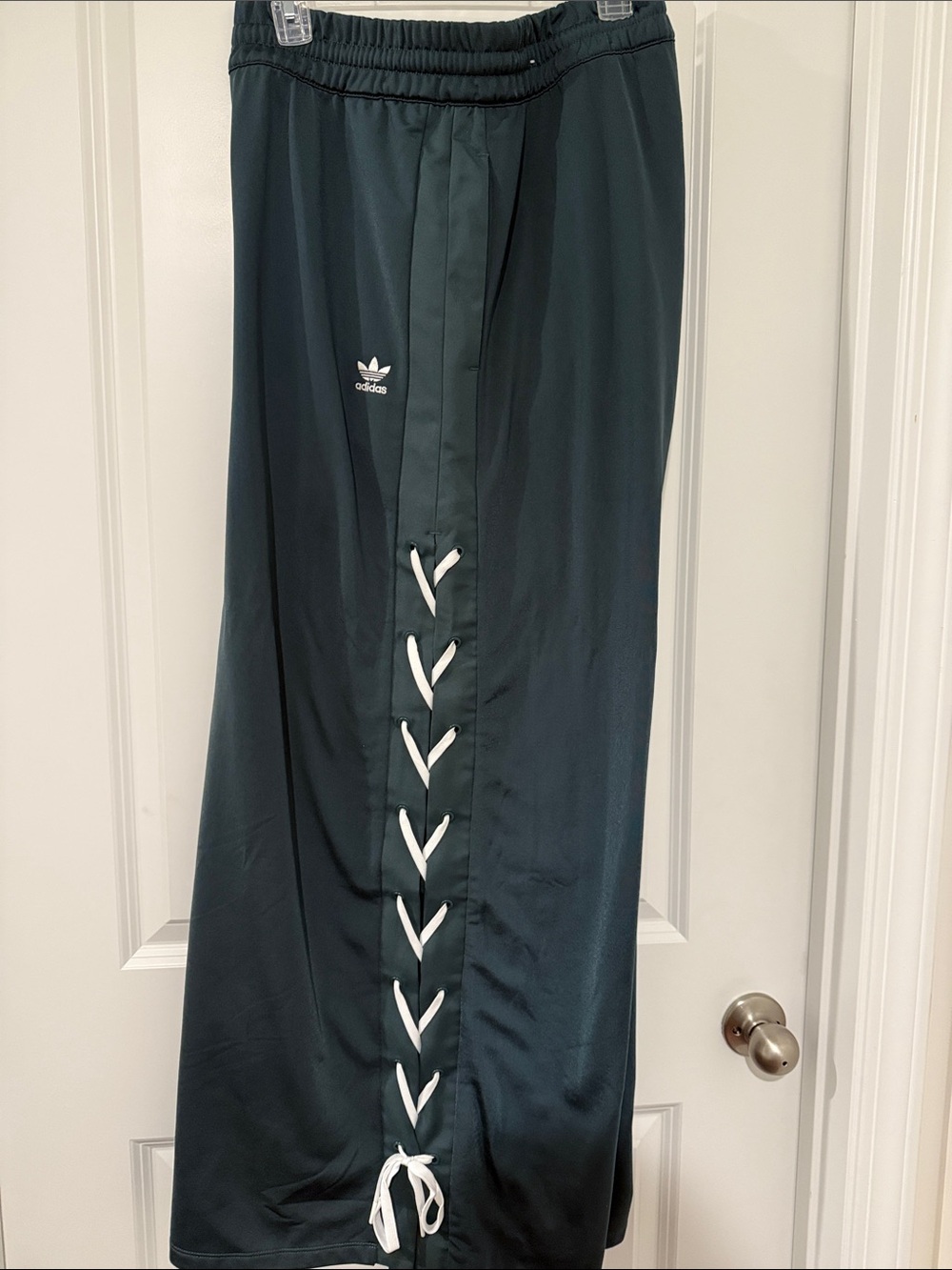 adidas dark green track pants with white lace-up detail